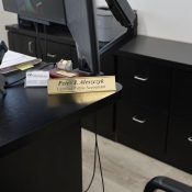 Desk with phone, computer, and nameplate of a certified public accountant.