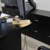 Desk with phone, computer, and nameplate of a certified public accountant.